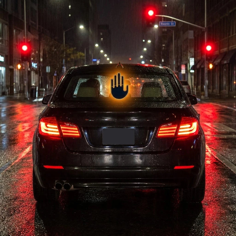 Amber LED hand sign glowing clearly in the rear window