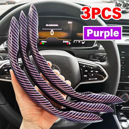 Three purple carbon fiber strips held in front of a car dashboard.