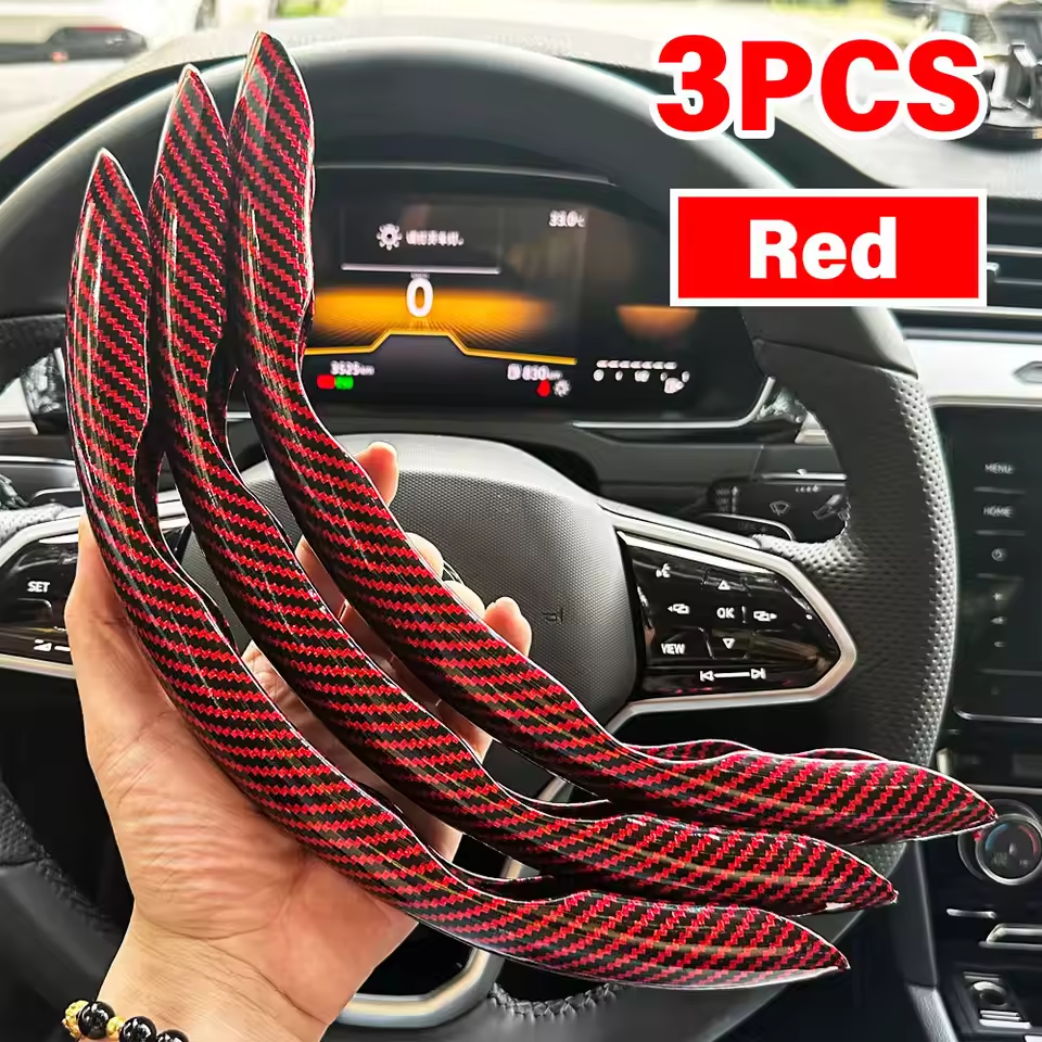 Three red carbon fiber strips held in front of a car's dashboard.