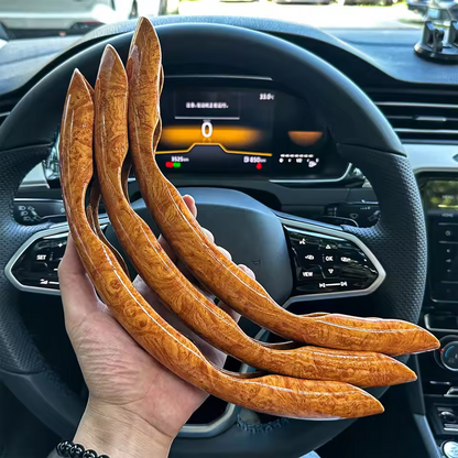 Wooden car steering wheel covers held in front of a car's dashboard.