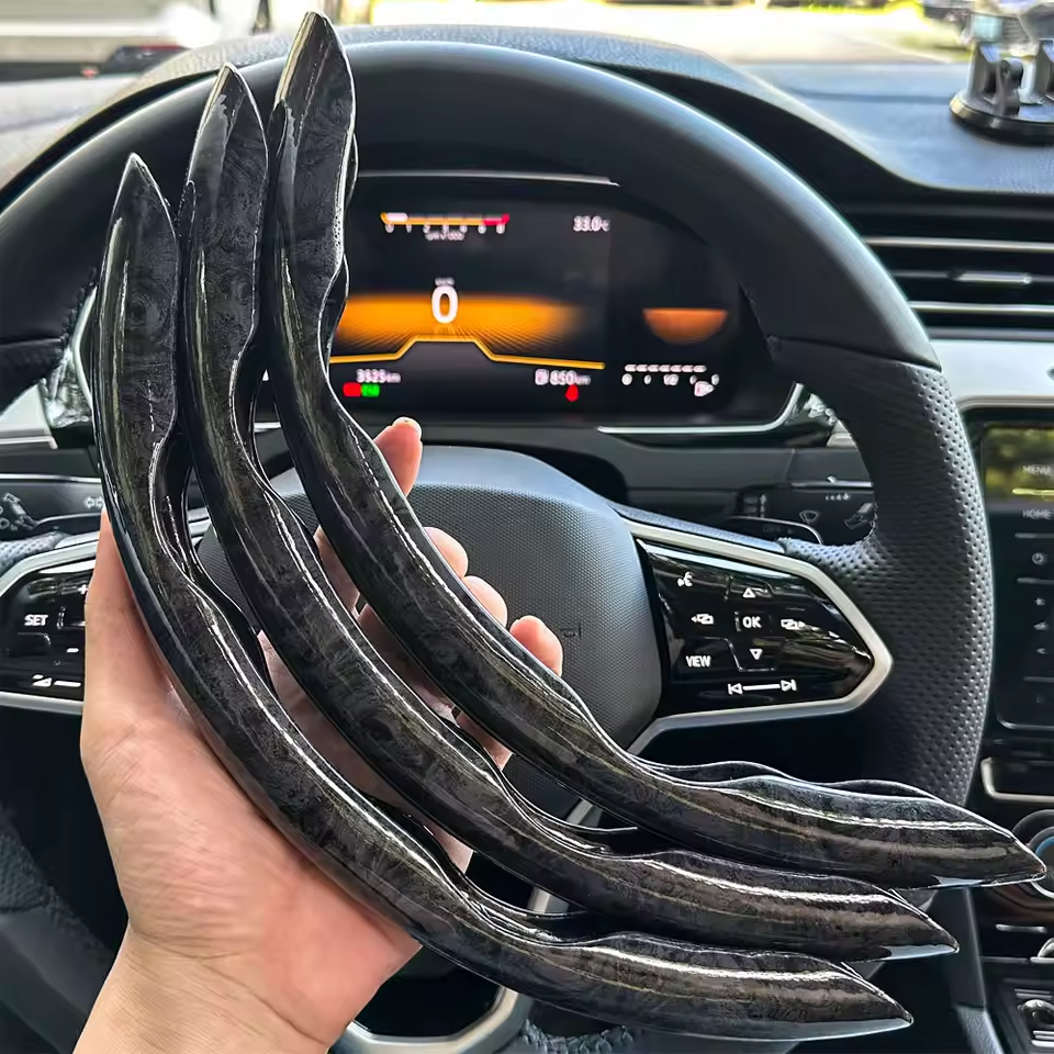 Person holding car steering wheel covers inside a vehicle