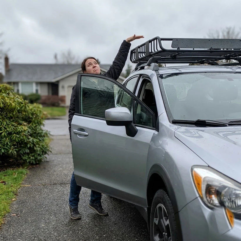 Driver on tiptoe unable to reach the SUV roof rack