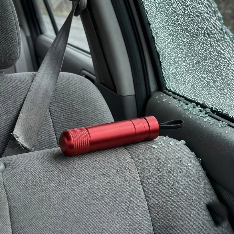 Broken side window and cut seatbelt with a clear exit