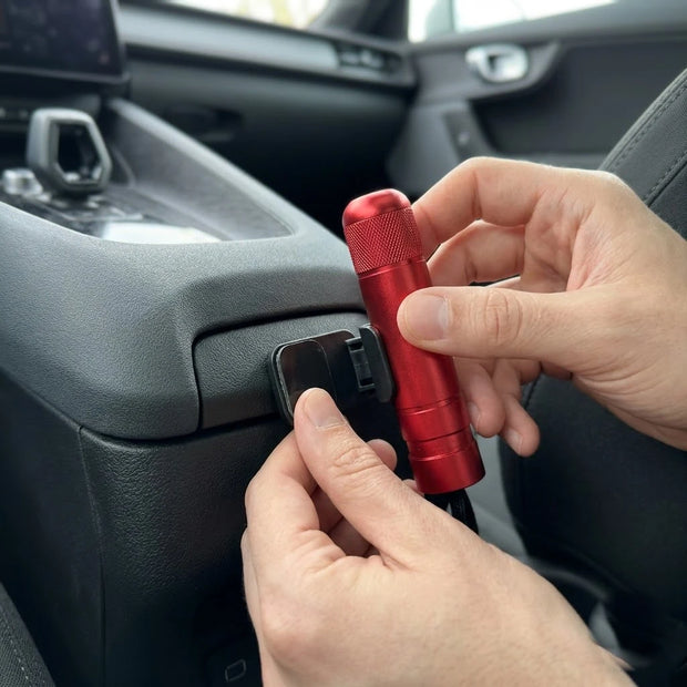 Hands mounting the BOLTHUT bracket on a car console