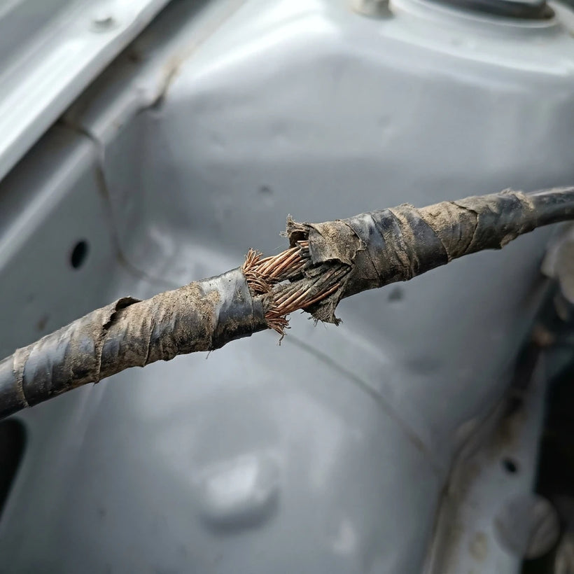 Frayed taped wire splice before repair
