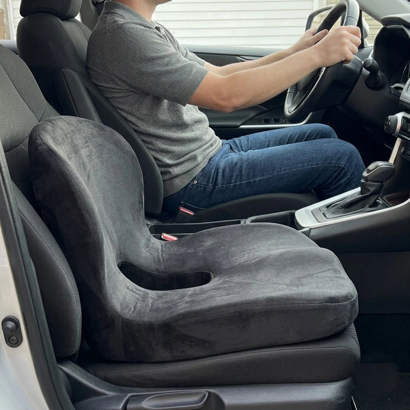 Same driver sitting upright and relaxed on the cushion