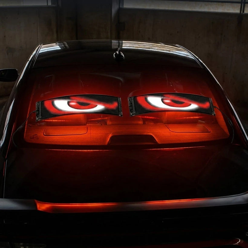 The same window lit up as bright animated RGB eyes