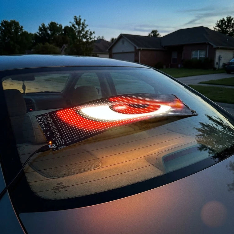 BOLTHUT RGB LED matrix panel glowing on a car window at dusk