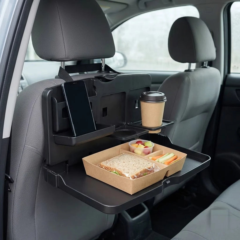 The same back seat with a BOLTHUT tray holding a meal and a drink