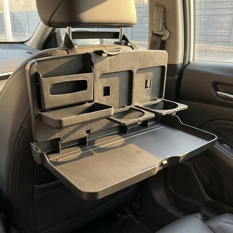 A BOLTHUT folding tray table resting open on a car seat in daylight