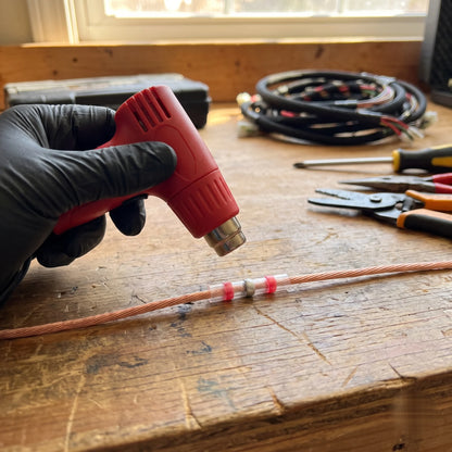 Solder seal connector sealed with a heat gun on a garage workbench - BOLTHUT